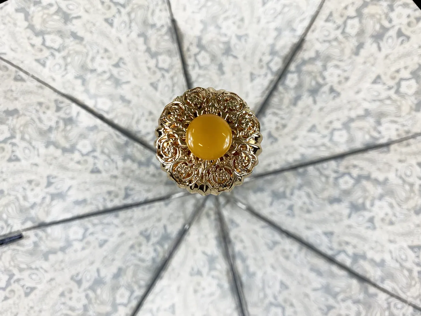Cream paisley design with yellow stone
